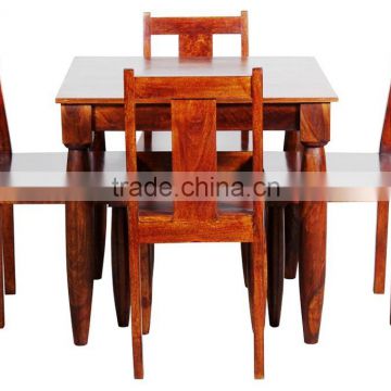 Shiny brown wooden dining set with four chairs