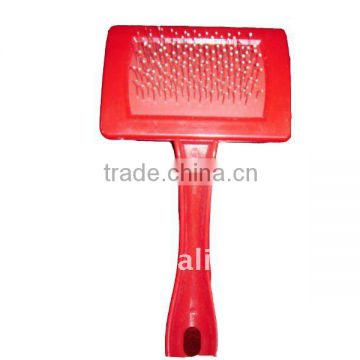 red plastic dog brush