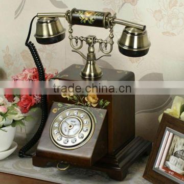 Decorative antique telephone with yellow flower on face