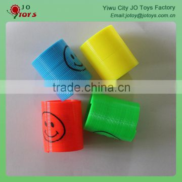 Small plastic slinky toy with smiling face