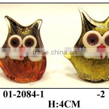 small glass owl with big eyes and red sharp mouth
