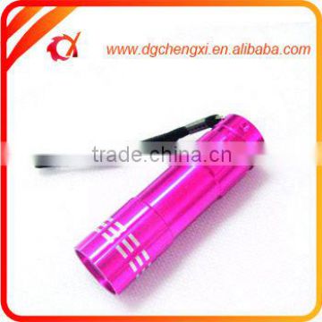 red aluminum led torch with string hanging