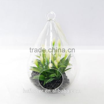Artificial Yellowish Bud and Fresh Leaves Plant in Water-drop Shaped Glass Terrarium