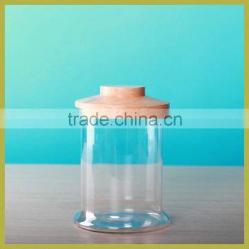 Large handmade glass storage jar with wooden lid