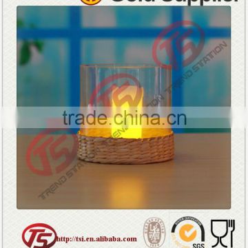 Clear glass candle holder with seagrass decoration