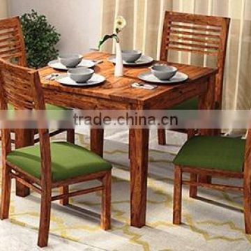 Walnut color four sitter wooden dining set with fabric chair