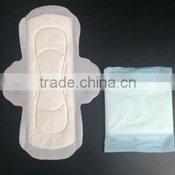 Disposable high absorbency dry surface sanitary napkin