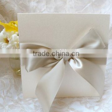 Ivory wedding invitation with bow