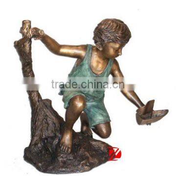 High quality brass playing boy statue with a boat sculpture