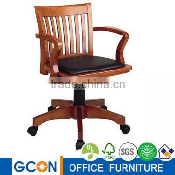 High back soiled wooden swivel dining room chair