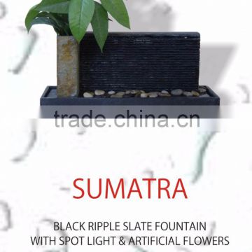 black ripple slate fountain with spot light and artificial flowers