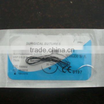 Surgical synthetic braided suture with reverse cutting needle