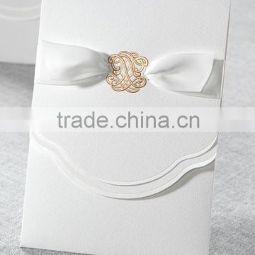 Glamorous & pure white wedding invitations with golden embossed pattern & white ribbons