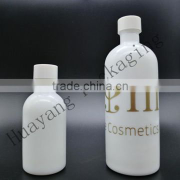 white ceremic glass bittle with outter cover and ball on the cap oilver glass bottle