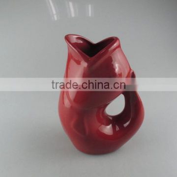 red-glazed ceramic fish vase