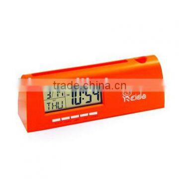Digital clock with pencil insertedSnooze and alarm