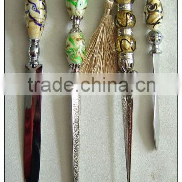 well-designed glass letter knife with tassels on the top of handle