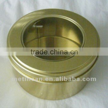 golden round tin box with clear top