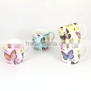 Ceramic mug with butterfly pictures in different colors.