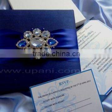 Blue Silk wedding Invitation with large embellishment.