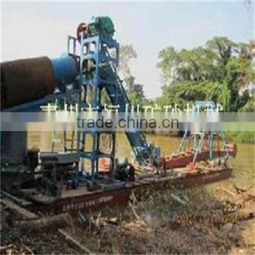 Small gold mining dredger in river