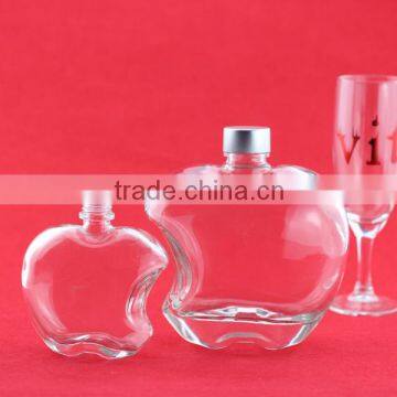 Competitive price elegant apple shape fruit wine bottles transparent glass bottle old wood shape bottles