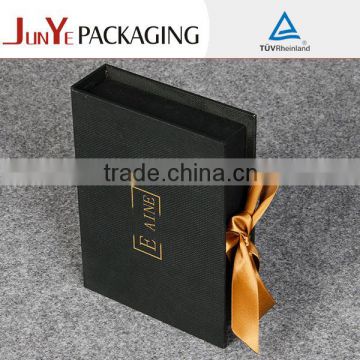Small cardboard paper folding gift box with ribbon