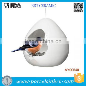 Simple white ceramic hummingbird feeder