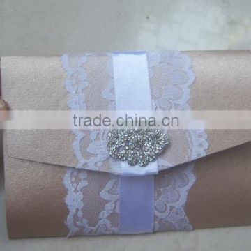 pocket fold wedding invites with lace and brooch for wedding invitation designers, wedding card manufacturers, wedding stationer