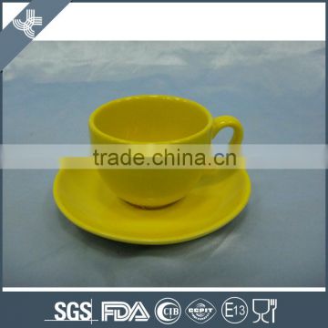 Model design with bright color ceramic coffee cup and saucer