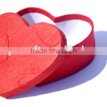 red cardboard heart shape gift box