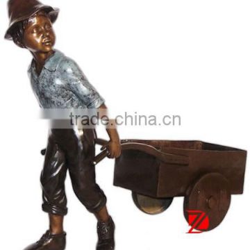 Casting bronze garden statue boy with hand buggy for sale