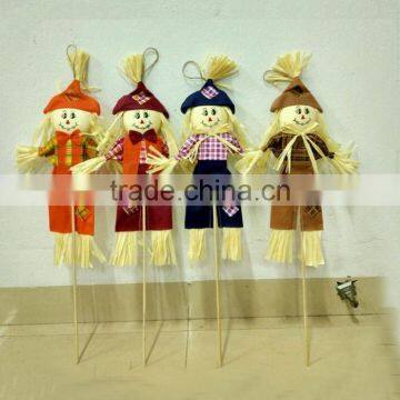 Paper straw and fabric scarecrow for autumn and harvest decoration