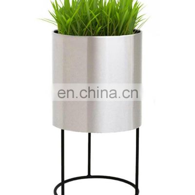 silver planter with black stand