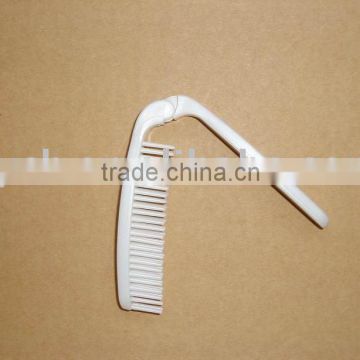 white disposable travel pocket comb
