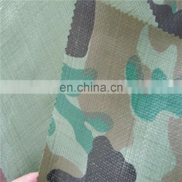 Camouflage poly tarp which is easy to use and install used for covering forest and woodland