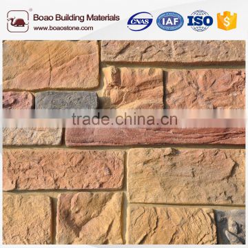 Artificial cultured stone wall cladding for interior fireplace mantel