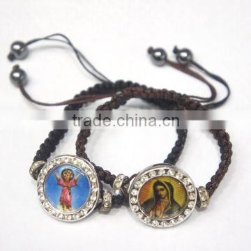 Hand-knitted bracelet with saint figure medal