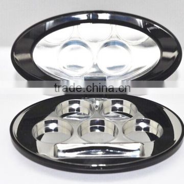 Oval shiny black compact container with shiny silver tray