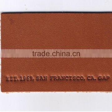 Custom & design embossed leather label for garment in dongguan