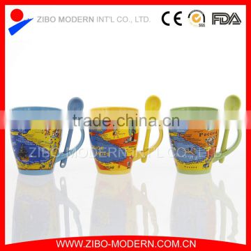 coloured ceramic coffee mug with design printing and spoon in handle
