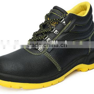 yellow outsole footwear and black upper leather work shoes for man