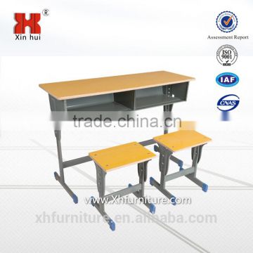 two students with the desks and chairs/school desk and bench