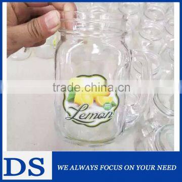 Glass mason jar with handle and decal for food