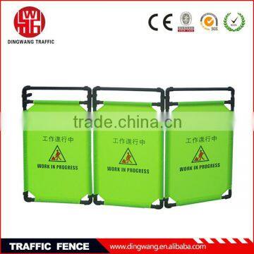 green fabric folding traffic fence