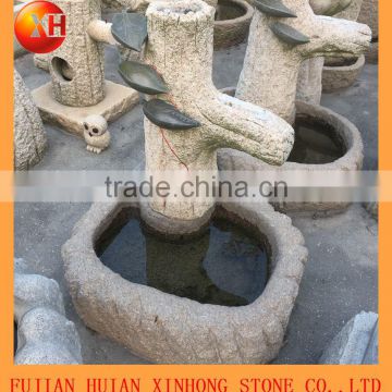 dancing stone water fountain with tree