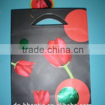 black shopping paper bag with flower