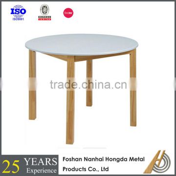 white solid wooden round dining table