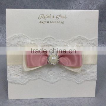 Hot sale charming white lace wedding invitations with pink ribbon bow&pearl decorations                        
                                                Quality Choice
