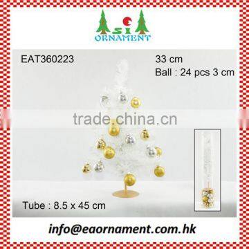 Set of gold and silver hanging balls and white artificial christmas tree